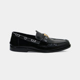 ARQS.PK 727 black leather loafers featuring a gold-tone metal bit and patterned side detailing.