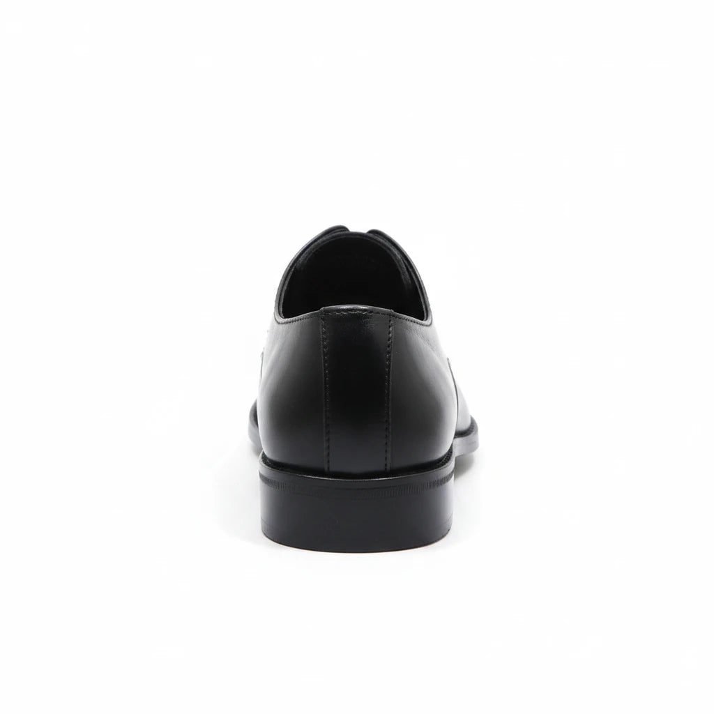 ARQS.PK black leather formal derby shoe viewed from the back showing the low-profile heel and smooth construction.