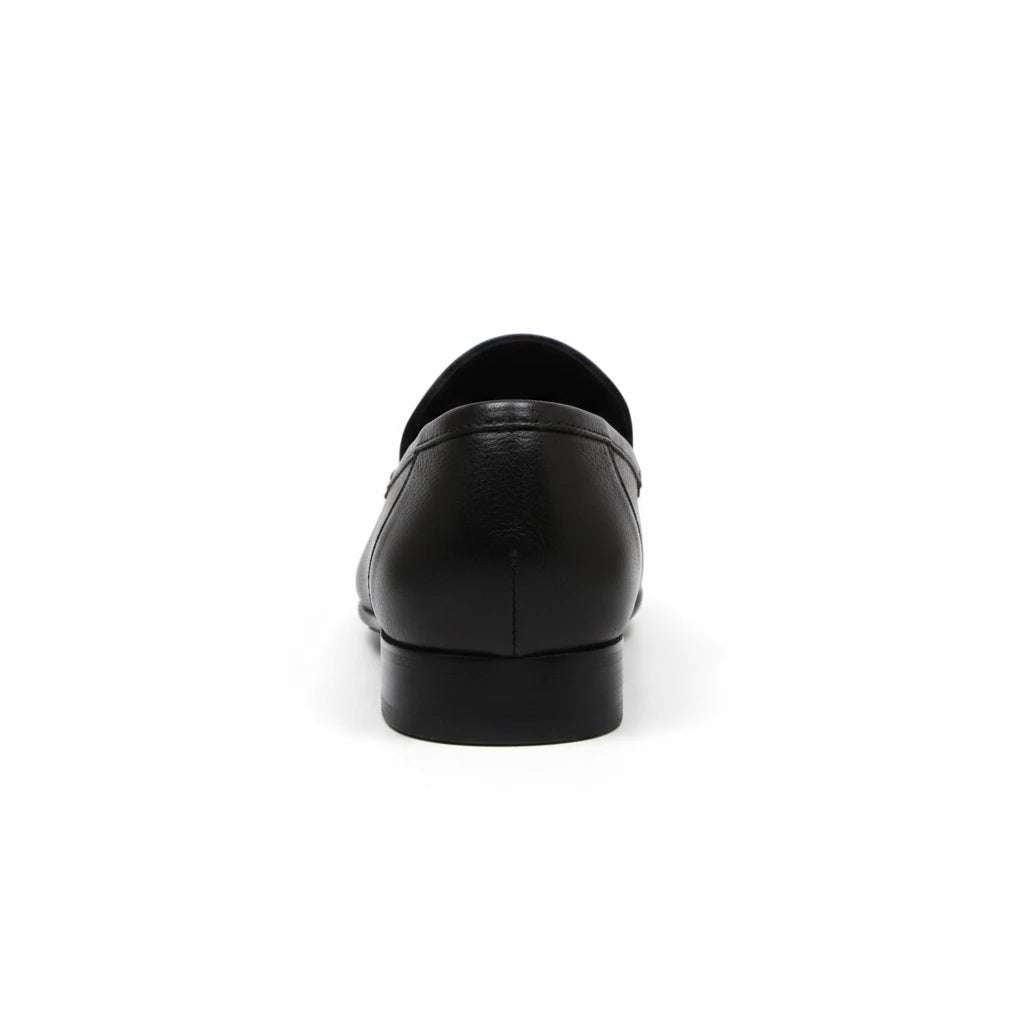 Back view of ARQS.PK black textured leather slip-on loafers with a low-profile heel on a white background.
