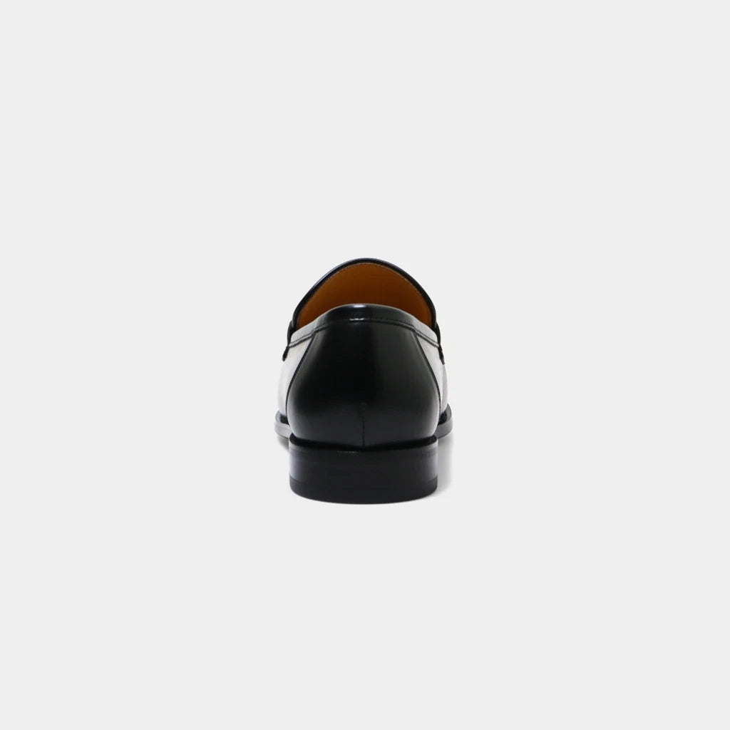 Rear view of ARQS.PK black leather penny loafer dress shoe with a smooth finish and durable heel
