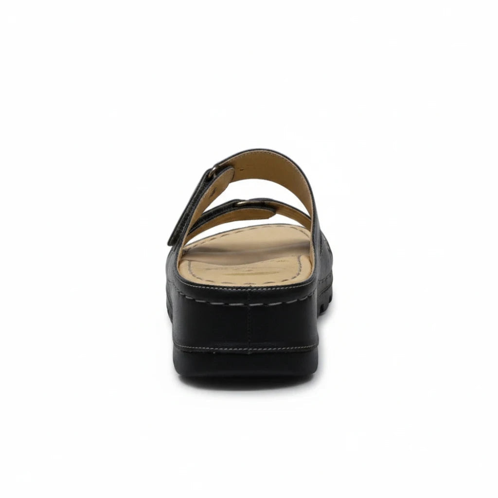 ARQS.PK black platform slide sandals with dual straps, contrast stitching, and a cushioned reflex-zone footbed