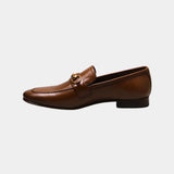 ARQS.PK tan leather loafers featuring a gold-tone horsebit detail on the vamp in a classic slip-on silhouette.